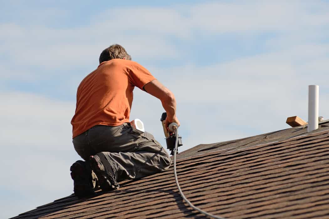 Roofing contractor working on asphalt roof in Peterborough, ON